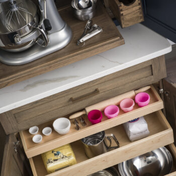 Kitchen cabinet roll-out shelves for bakeware and cookware from Dura Supreme Cabinetry
